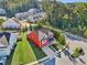 Red two-story house in a residential neighborhood with landscaping and driveway at 100 Academy Ln, Canton, GA 30114