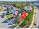 Red two-story home in a neighborhood with trees and other houses at 100 Academy Ln, Canton, GA 30114