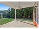 Covered back porch with concrete floor and green landscaping at 100 Academy Ln, Canton, GA 30114