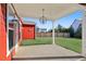 Spacious covered back porch with a concrete floor and grassy backyard at 100 Academy Ln, Canton, GA 30114
