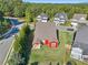 Aerial view of backyard with covered patio, green grass, and trees at 100 Academy Ln, Canton, GA 30114