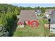 Aerial view of a backyard with green grass, trees, and a covered patio area at 100 Academy Ln, Canton, GA 30114