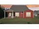 Charming red home with covered back porch and spacious backyard at sunset at 100 Academy Ln, Canton, GA 30114