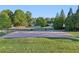 Neighborhood basketball court surrounded by trees and grass at 100 Academy Ln, Canton, GA 30114