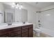 Bathroom with double vanity, shower/tub combo, and neutral color scheme at 100 Academy Ln, Canton, GA 30114