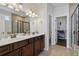Bathroom featuring dual vanities, a walk-in shower, and a closet at 100 Academy Ln, Canton, GA 30114