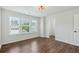 Empty bedroom featuring wood-style flooring, windows, and a walk-in closet at 100 Academy Ln, Canton, GA 30114