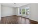 Bright, empty bedroom with wood-style floors and multiple windows at 100 Academy Ln, Canton, GA 30114