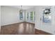Dining room with wood-style flooring, abundant natural light from large windows, and an entry door at 100 Academy Ln, Canton, GA 30114