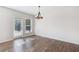 Dining area with wood-style flooring, a door to the backyard, and a modern light fixture at 100 Academy Ln, Canton, GA 30114