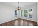 Bright dining room featuring wood-style floors, large windows, and a stylish light fixture at 100 Academy Ln, Canton, GA 30114