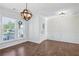 Dining room with wood floors, chair rail molding, entry door with sidelights, and updated light fixture at 100 Academy Ln, Canton, GA 30114