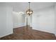 Dining room with wood-style flooring, a chandelier, and wainscoting at 100 Academy Ln, Canton, GA 30114