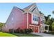 Attractive red two-story house with a large front porch and an attached garage at 100 Academy Ln, Canton, GA 30114
