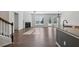 Open-concept living area with fireplace, wood floors, and staircase at 100 Academy Ln, Canton, GA 30114