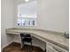 Built-in office nook with granite countertop, cabinets, and folding chair at 100 Academy Ln, Canton, GA 30114