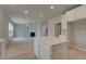 Open kitchen with large island, white cabinets and views to Gathering room at 565 Teversham Dr, Mcdonough, GA 30253