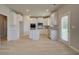 Bright kitchen with white cabinets, island, and backyard access at 565 Teversham Dr, Mcdonough, GA 30253