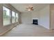 Living room with corner fireplace and ceiling fan at 565 Teversham Dr, Mcdonough, GA 30253