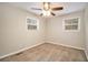 Well-lit bedroom with neutral walls, plush carpeting, and a ceiling fan at 2671 Tilson Rd, Decatur, GA 30032
