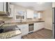Modern kitchen with granite countertops, white cabinets, and stainless steel appliances at 2671 Tilson Rd, Decatur, GA 30032