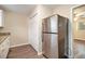 Eat-in kitchen with stainless steel refrigerator and ample cabinet storage at 2671 Tilson Rd, Decatur, GA 30032