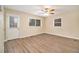 Spacious living area featuring hardwood floors, a ceiling fan, and an exterior door at 2671 Tilson Rd, Decatur, GA 30032