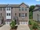 Three-story brick townhome with two-car garage and balcony at 2042 Violet Ln, Brookhaven, GA 30319