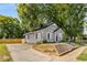 Newly renovated craftsman home with gray siding, and a large tree in front at 130 South Se Ave, Marietta, GA 30060