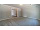 Spacious bedroom with gray carpet and access to hallway at 1414 Alcovy Station Rd, Covington, GA 30014