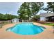 Inviting kidney-shaped pool with concrete decking at 648 Clubland Se Cir, Conyers, GA 30094