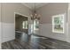 Bright dining room with hardwood floors, wainscoting, and chandelier at 1422 Alcovy Station Rd, Covington, GA 30014