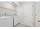 Laundry room with washer, dryer, and shelving at 2849 Weston Brook Ln, Duluth, GA 30096