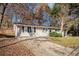 Ranch style home with a long driveway and mature trees at 195 Pinehurst Dr, Stockbridge, GA 30281