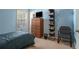 Blue bedroom with single bed, dresser, and built-in shelving at 5955 Raventree Ct, Atlanta, GA 30349