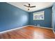 Blue bedroom with hardwood floors, ceiling fan and window at 1097 Chatsworth Dr, Avondale Estates, GA 30002