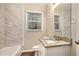 Updated bathroom with granite countertop, tile shower, and a bathtub at 2791 Mcafee Rd, Decatur, GA 30032