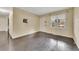 Bright living room with dark hardwood floors and window at 125 W South St, Canton, GA 30114