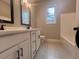 Bathroom with double vanity, white cabinets, black hardware, and tiled floor at 37 Harmony Ridge Dr, Temple, GA 30179