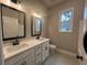 Dual vanity bathroom with white cabinets and large mirrors at 37 Harmony Ridge Dr, Temple, GA 30179