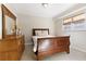 Basement bedroom with a wooden sleigh bed and dresser at 610 Americas Cup Cv, Alpharetta, GA 30005