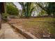 Sloped backyard with stone retaining wall and steps at 1098 Jefferson Ave, Atlanta, GA 30344