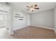 Empty bedroom with gray walls, wood-look flooring, ceiling fan, and open doorway to bathroom at 210 Sampson Ne St # Apt 6, Atlanta, GA 30312