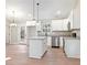 Modern kitchen with white cabinets, granite countertops, and island at 76 E Ranchette Rd, Temple, GA 30179