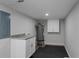 Finished basement laundry area with white cabinets and granite countertop at 1052 Donnelly Sw Ave, Atlanta, GA 30310