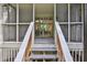 Screened porch with gray deck and stairs leading to the yard at 4717 Clemmons Drive, Ellenwood, GA 30294