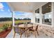 Covered patio with wooden table and chairs, offering a relaxing outdoor space at 1693 Juniper Berry Way, Loganville, GA 30052