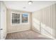Bedroom with window and wood-paneled walls at 1742 Lynn Ln, Decatur, GA 30032