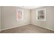 Well-lit bedroom featuring neutral walls and carpet at 1742 Lynn Ln, Decatur, GA 30032