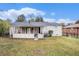 Back of house with covered patio, fenced yard, and neighboring home at 1742 Lynn Ln, Decatur, GA 30032